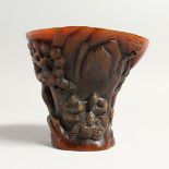 A CARVED HORN LIBATION CUP 5ins high.