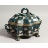 AN UNUSUAL GREEN GLAZED POTTERY TUREEN AND COVER, enamel decorated with stylised flowers with