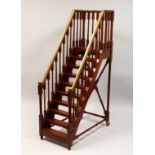 A GOOD MAHOGANY AND BRASS MODEL OF A STAIRCASE, with nine treads, platform top, brass mounted hand