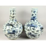 A PAIR OF CHINESE BLUE AND WHITE BULBOUS VASES with long necks 24ins high.