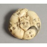 A CARVED BONE FIVE FACE NETSUKE 1.25ins diameter