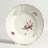 A 19TH CENTURY MEISSEN CIRCULAR PLATE with gilt waved border and painted with flowers Cross swords