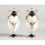 AN EARLY 20TH CENTURY MINTON PAIR OF TWO-HANDLED PEDESTAL, OVOID VASES painted by Dudley, signed,