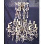 A good large wrought iron and cut glass Venetian style chandelier. A GOOD LARGE WROUGHT IRON AND CUT