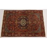 A PERSIAN BAKHTIYAR RUG, red ground with all over floral decoration. 6ft 11ins x 4ft 7ins.