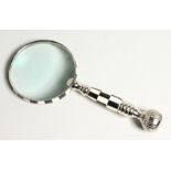 A MAGNIFYING GLASS with a chequered handle.