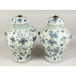 A PAIR OF BLUE AND WHITE CHINESE VASES AND COVERS