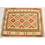 A CAUCASIAN DESIGN KEILIM CARPET of typical form with geometric decoration. 6ft 8ins x 5ft.