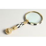 A MAGNIFYING GLASS with a chequered handle.