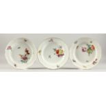 A SET OF THREE 19TH CENTURY MEISSEN CIRCULAR PLATES painted with flowers. Cross swords mark in blue.