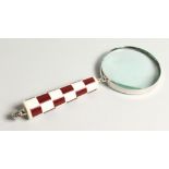 A MAGNIFYING GLASS with a chequered handle.