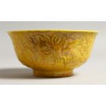 A YELLOW CHINESE CIRCULAR BOWL the side with dragon in relief