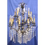 A SMALL WROUGHT IRON AND CUT GLASS CHANDELIER.