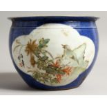A CHINESE BLUE GROUND JARDINIERE with panels of birds. 7.5ins diameter.