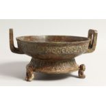 A SMALL CHINESE ARCHAIC BRONZE TWO HANDLED CENSER on three animal legs. 8ins diameter.