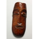 A CARVED BONE MASK, possibly LEGA 8ins x 3.5ins.