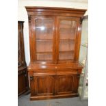 A Victorian walnut cupboard bookcase.