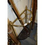 A brass and cast iron demi-lune walking stick stand.