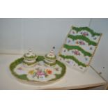 A porcelain desk set comprising a tray with two inkwells and a letter rack, all floral decorated