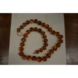 An amber bead necklace.