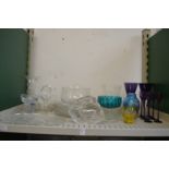 A shelf of decorative and household glass.
