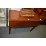A small mahogany drop-leaf table with a drawer to each end.