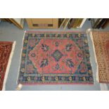 A small pink ground Persian rug.