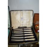 A cased set of six silver handled butter knives.