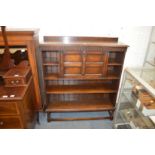 An oak bookcase with drop-flap.