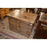 A 17th century oak chest of drawers with three long geometrically moulded drawers.