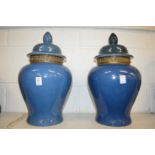 A large pair of Chinese blue glazed temple jars and covers.