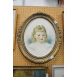 An oval portrait of a young girl watercolour, in a decorative gilt frame.