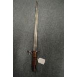 A bayonet with leather covered scabbard, a leather swagger stick and the nose of shell /