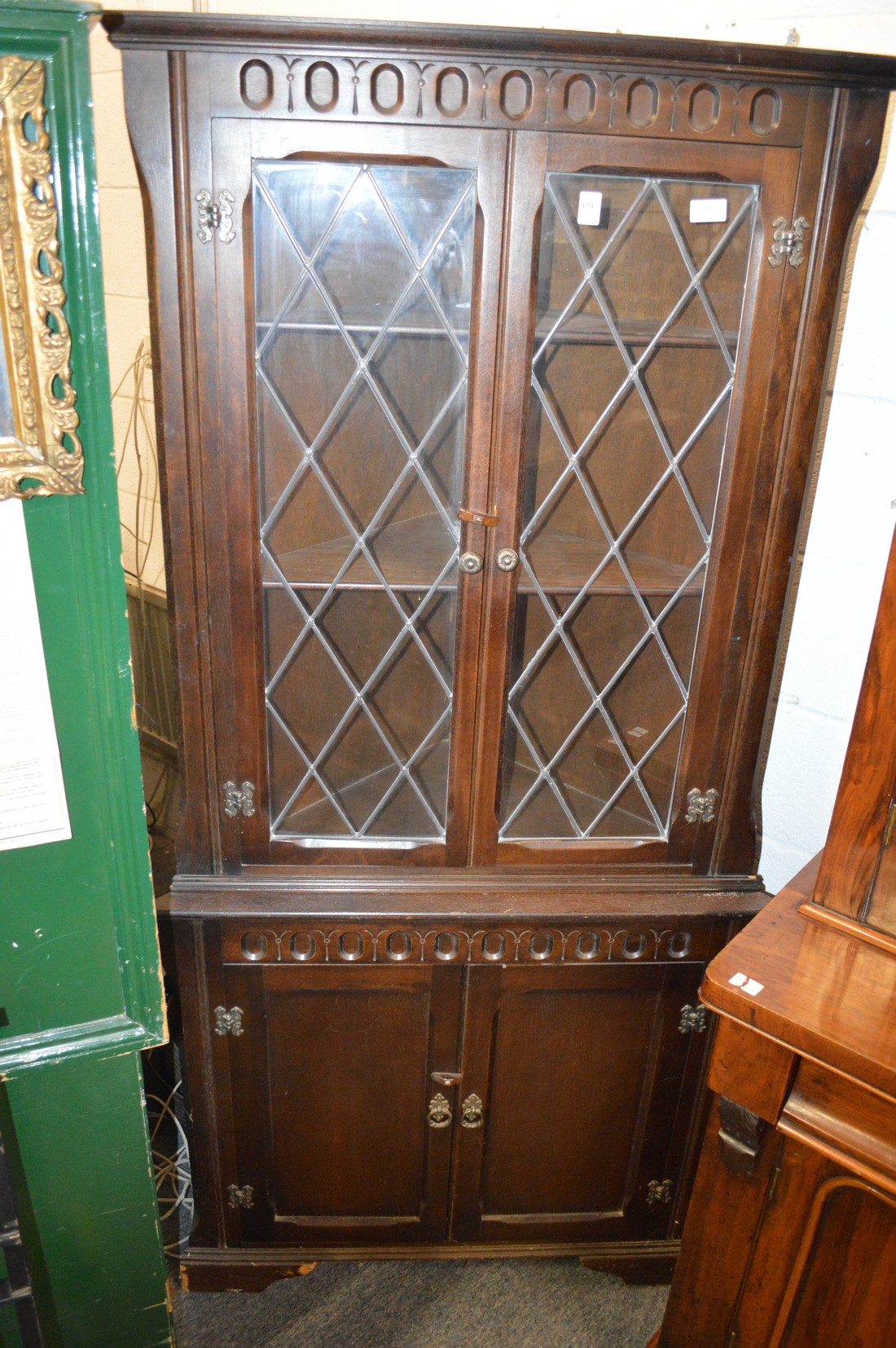 A floor standing four door corner cupboard.