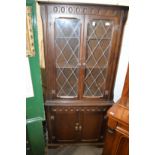 A floor standing four door corner cupboard.