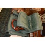 An Ekornes green leather upholstered reclining swivel armchair with matching stool.