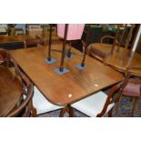 A George III mahogany tilt top breakfast table with rounded rectangular top, turned column support