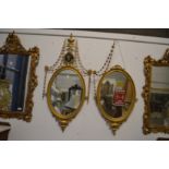 A very good pair of Adam revival gilt framed oval mirrors with urn finials, harebell swags, small