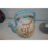 A Chinese teapot with faux bamboo handle and spout.