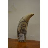 A reproduction scrimshaw tooth.