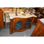 A Victorian walnut serpentine fronted side cabinet with marble top, a pair of mirrored doors on a