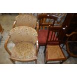 A pair of oak framed armchairs and two other chairs.