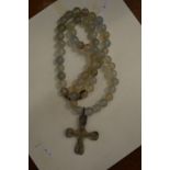 A Roman bronze cross on a bead necklace.