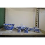 Two shelves of blue and white china together with a floral decorated trio.