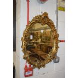 A gilt framed mirror.