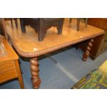A rosewood extending dining table.