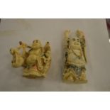 Two carved bone Buddhas.