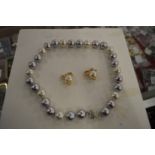 A chunky pearl necklace and earrings.