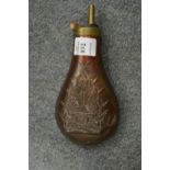 A copper powder flask.