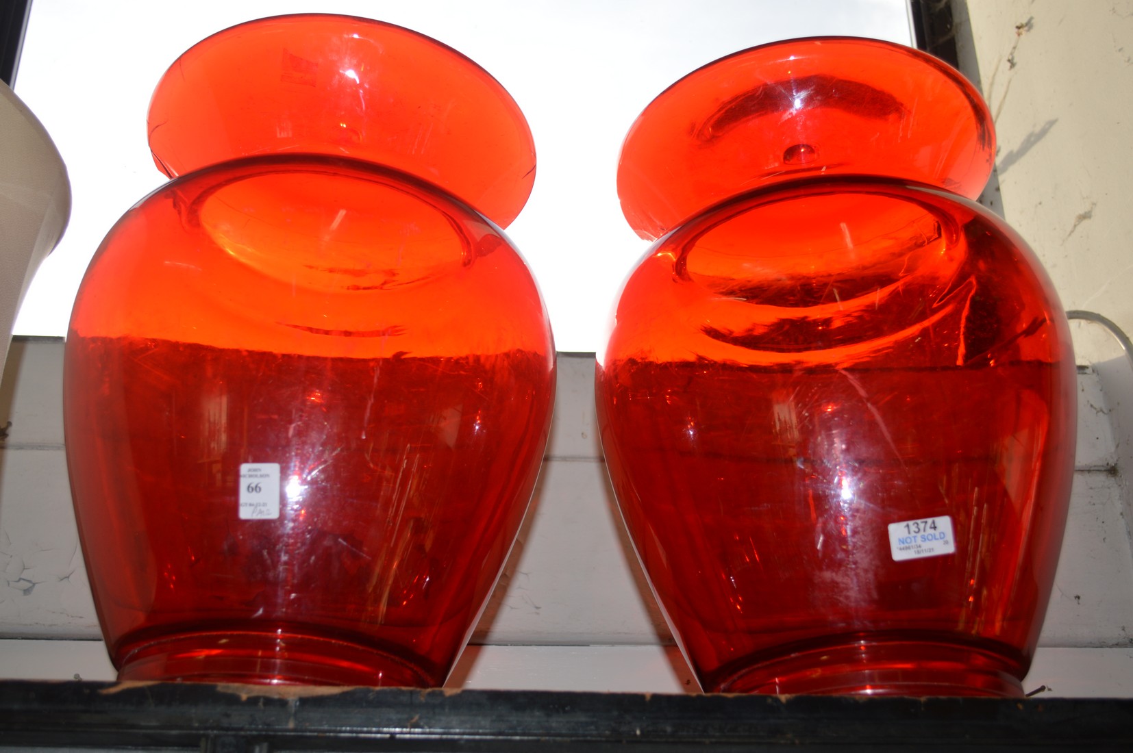 A pair of stylish red perspex stands.